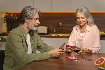 Mature married couple playing a card game