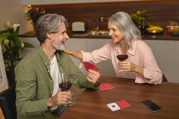 Male showing his cards to his wife