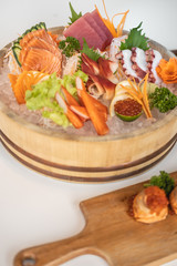 Sashimi set manus on bucket ice, white background 