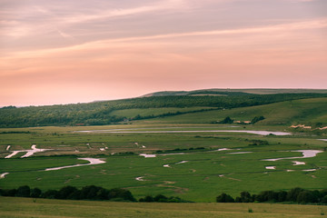 Fototapeta na wymiar Sunset over the river Cuckmere flowing through the East Sussex countryside