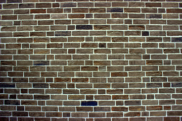  Gray brickwork of a wall with an insert of brown bricks. Wallpaper in retro style.