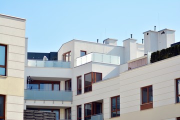 Contemporary residential building exterior in the daylight. Modern apartment buildings on a sunny day with a blue sky. Facade of a modern apartment building