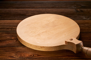 Background with cutting board on wooden table Space of wooden top Wooden background with wooden table and round cutting board