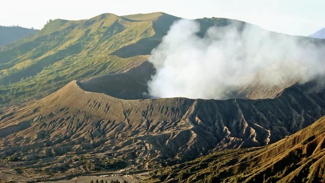 Steaming crater of Mount Bromo , active volcano in East Java, Indonesia,  from viewpoint.