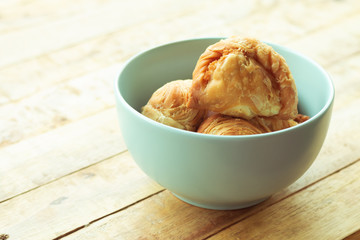 Curry puff pastry in cyan vintage bowl put on old table with copy-space