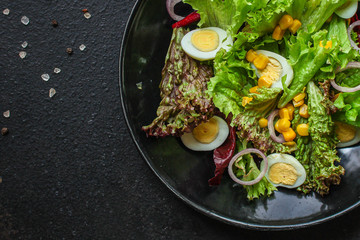 healthy salad corn, quail eggs, leaves mix (green vitamins) menu concept. food background. top view. copy space