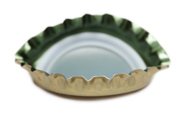 Golden bottle cap for beer isolated on white, macro