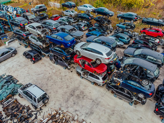 Damaged cars waiting in a scrapyard to be recycled or used for spare parts