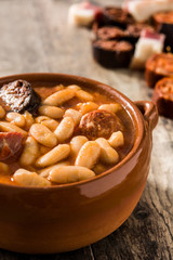 Typical Spanish fabada asturiana on wooden table