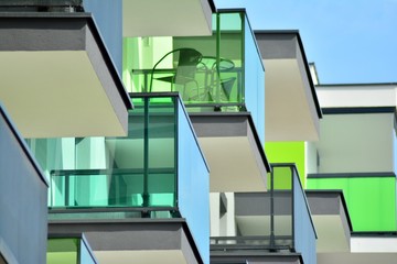 Contemporary residential building exterior in the daylight. Modern apartment buildings on a sunny day with a blue sky. Facade of a modern apartment building
