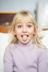 Cute little girl sticking out her tongue