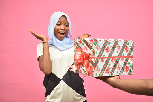 Pretty Young Black Woman Feeling Excited While Getting A Gift From Someone