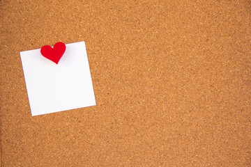cork board with red heart note