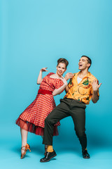 excited dancers dancing boogie-woogie on blue background