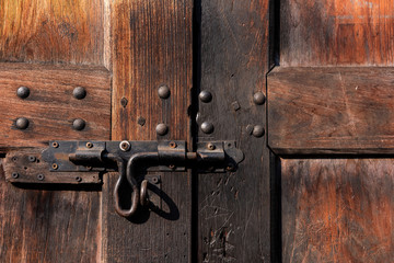 Old lock on wooden door Close-up padlock on old wooden door.