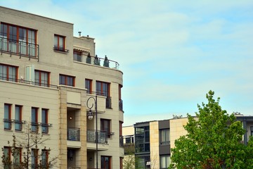 Contemporary residential building exterior in the daylight. Modern apartment buildings on a sunny day with a blue sky. Facade of a modern apartment building