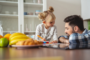 Fototapeta premium Sweet little girl spending time with father at home