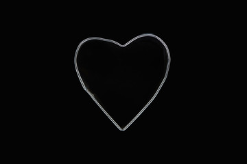 Top view of metal wire in heart shape isolated on black