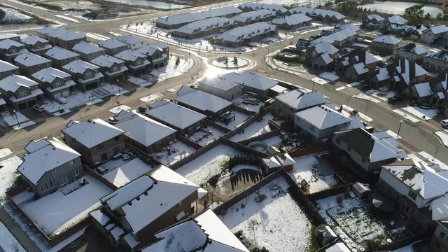 Ascending Aerial Over Neighborhood With Cul De Sac In Middle In Winter