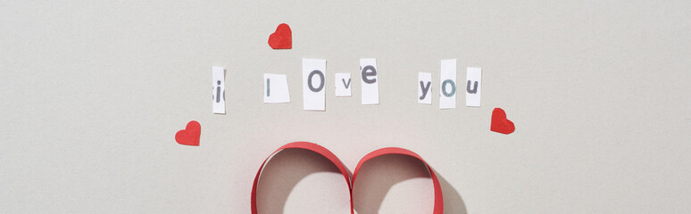 Top view of i love you lettering with paper hearts on grey background, panoramic shot
