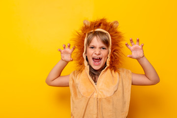 Little girl in lion costume roaring