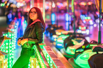 Fototapeta na wymiar girl having fun in amusement park at night