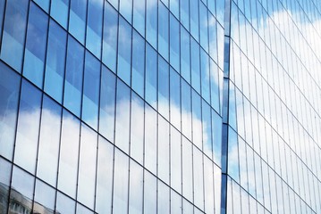 Abstract image of looking up at modern glass and concrete building. Architectural exterior detail of office building. 