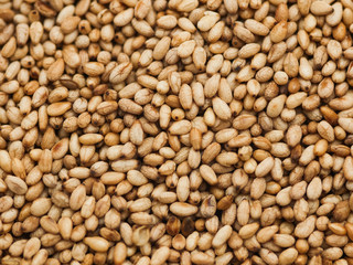 Many of Toasted sesame seeds top view of background