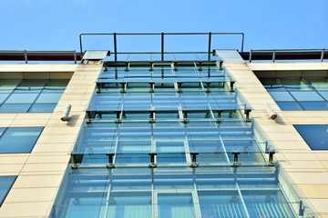 Abstract image of looking up at modern glass and concrete building. Architectural exterior detail of office building. 