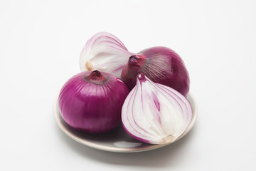 Half sliced onion in a plate isolated