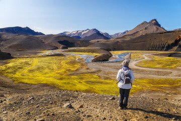 Woman oking at an amazing Landscape in Landmannalaugar, Iceland