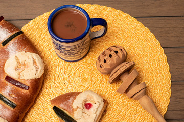 Traditional Epiphany cake, chocolate and a grinder on a wooden table