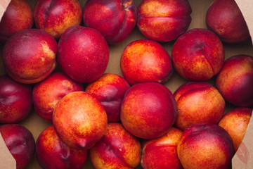 Fototapeta na wymiar Farm Fresh Organic Heavenly Peaches in a box