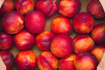 Fototapeta na wymiar Farm Fresh Organic Heavenly Peaches in a box