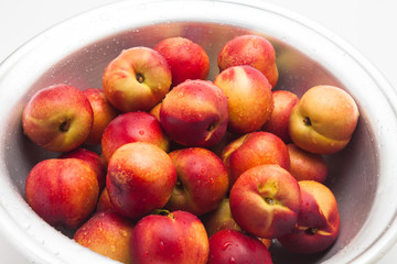 Many of ripe peaches on a basket 