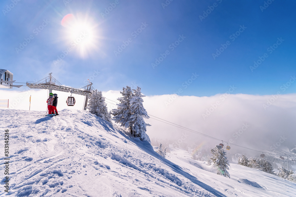 Canvas Prints Sun flares and Red Cable cars in Zillertal Arena ski resort in Tyrol in Mayrhofen in Austria in winter Alps. Chair lifts in Alpine mountains with white snow and blue sky. Downhill fun at snowy slopes.