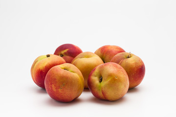 Group of ripe peaches on a white