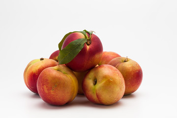 Group of ripe peaches on a white