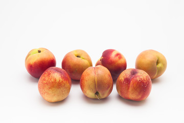 Group of ripe peaches on a white