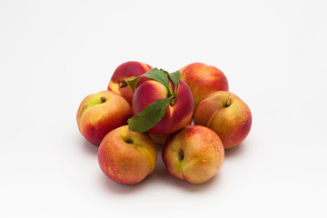 Group of ripe peaches on a white