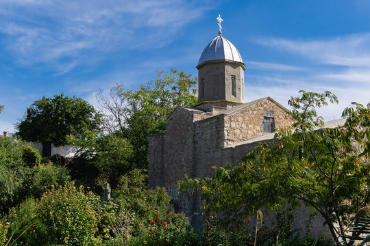 View of Orthodox Church of Iverskaya Our Lady or Armenian Church as Church of John Baptist. Was built of early 14th century. Сurrent temple. Feodosia, Crimea, Russia - September, 2019
