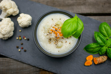 Cauliflower soup with fresh turmeric and colored pepper. View from
