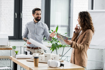 smiling virtual reality architect talking with colleague in office