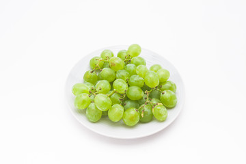 Fresh green grapes on the plate 