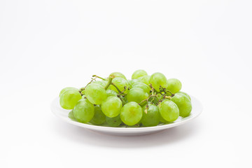 Fresh green grapes on the plate 