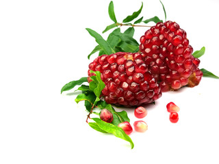 Pomegranate seeds, red fruits and leaves, isolated on a white background, herbs.
