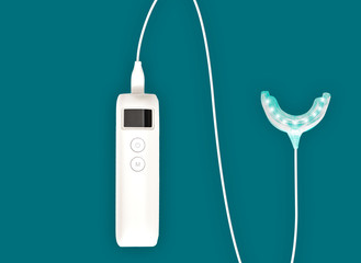 Professional teeth whitening kit - luminous mouth trail isolated connected with controller on turquoise background on the left hand side
