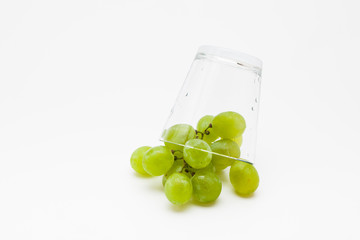  Fresh green grapes with glass cup isolated 