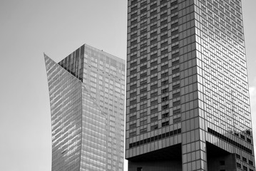 Obraz premium Abstract image of looking up at modern glass and concrete building. Architectural exterior detail of office building. 
