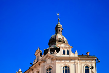 Fototapeta na wymiar Tower of Town Savings bank on Trg Svobode, or Liberty Square in Old city in Maribor in Slovenia in Europe. Lower Styria in Slovenija. Blue sky and sunny day. Building architecture. Facade exterior.